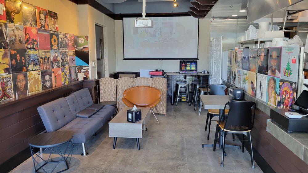 Inside Deli Seoul — vinyl records on the walls, cozy seating area, and open kitchen